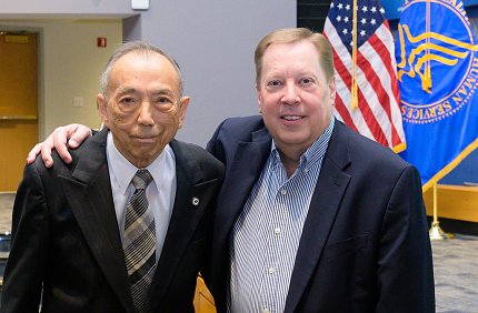 Chen and Whitehead in Masur with US and HHS flags behind