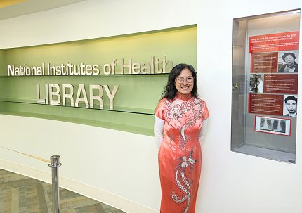 Wong stands next to the exhibit