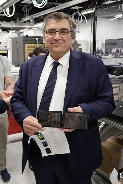 Samuel holding assay plates in a lab