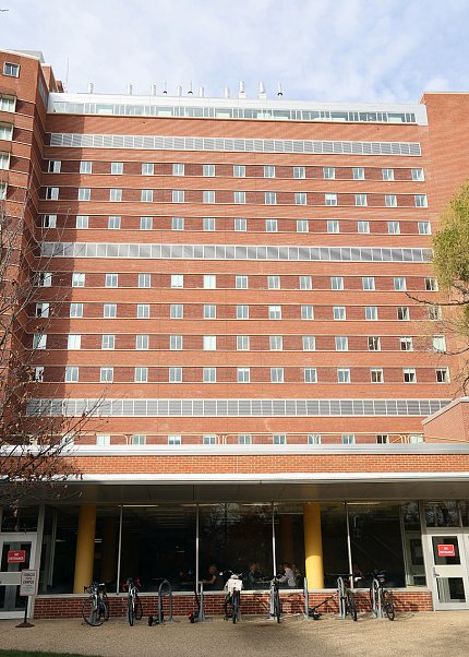 The exterior of the E wing, a multistory brick building with many windows
