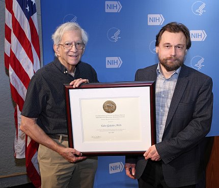 Hodes and Gladyshev hold framed Mahoney Lecture award plaque