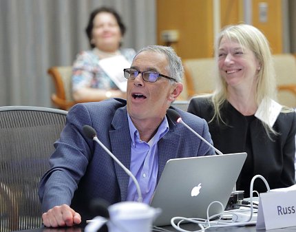 Seated at a conference table, Altman and Bargmann laugh.