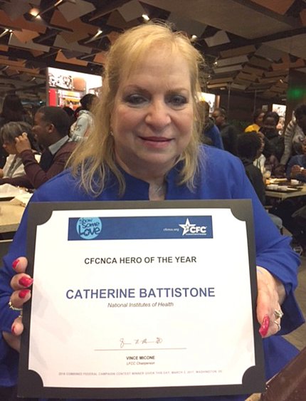 Battistone proudly holds her plaque.