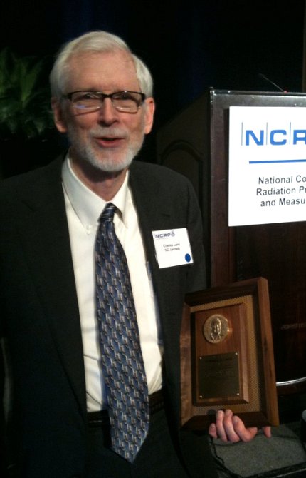 Dr. Land poses with honorary plaque