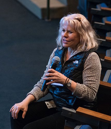 Dr. Rachel Caspi speaking into a microphone.