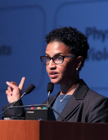 Julie Berko speaks at town hall meeting.