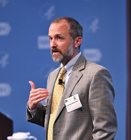 Dr. Curlin gestures at the podium.