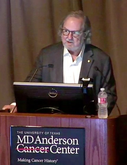 Dr. Allison speaks at lectern.