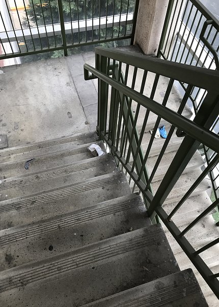 Masks are discarded in a campus parking garage stairwell