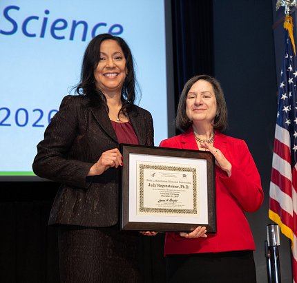 Dr. Clayton presents plaque to Dr. Regensteiner