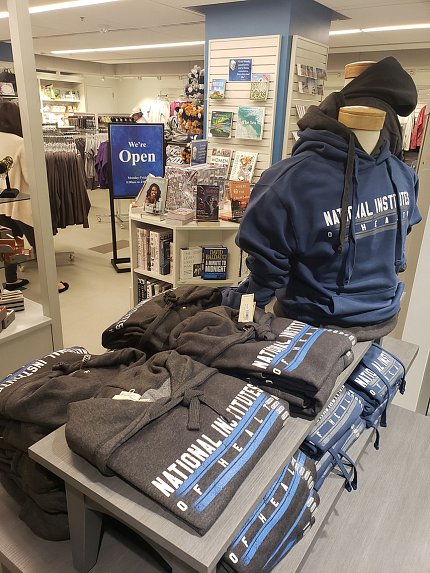 view inside bookstore showing shelves with NIH logo merchandise in foreground