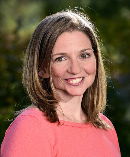 A smiling Cassandra Hayne standing outside 