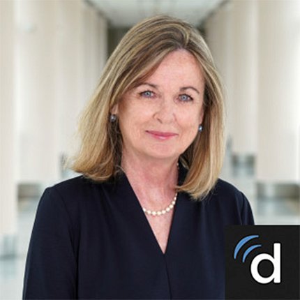 Head shot of Kathleen Conry-Cantilena standing in a hallway of large white columns