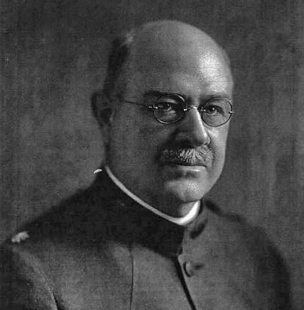 A black and white head shot of Dr. Kinyoun