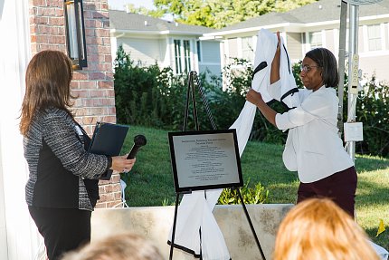 Rogers lifts covering from plaque 