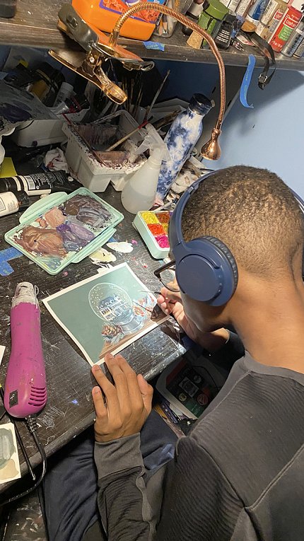 A view from overhead as Alex Berko designs the holiday card