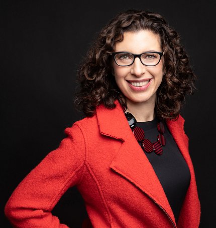 A smiling Ranney wearing a red blazer
