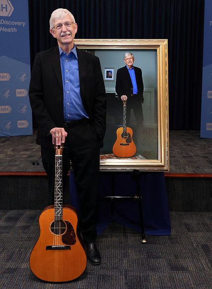 Collins with his guitar stands next to official portrait of him standing with his guitar