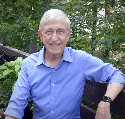 Collins smiling, sitting outside