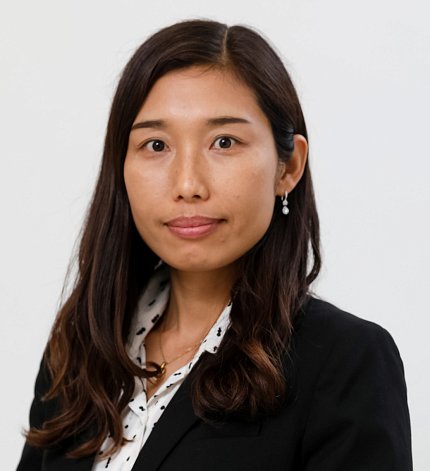 Ahn, wearing a black jacket and polka-dot shirt, poses against a white backdrop.
