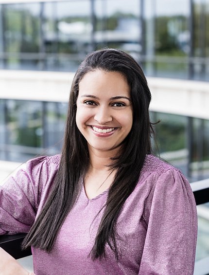 Headshot of a smiling Fuentes, wearing a mauve shirt.