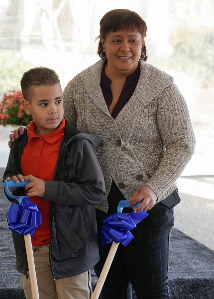 Angel and his mother hold shovels