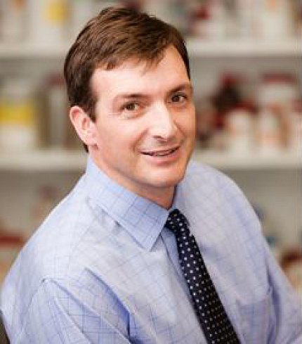 Robinson smiles over his right shoulder at the camera.