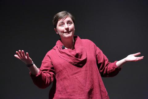 Dr. Hinde speaks onstage.