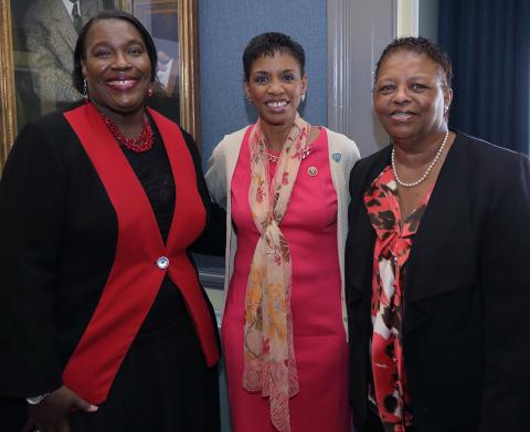 Three women stand next to each other