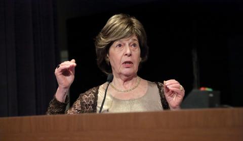 Dr. Berman lectures at podium.