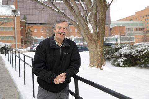 Mueller, with snow covered NIH grounds behind him
