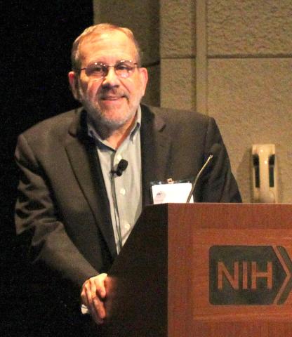 Sanes behind NIH podium