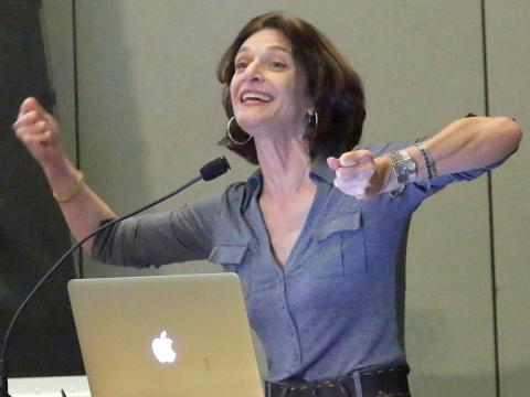 A smiling Dr. Adolph with arms extended