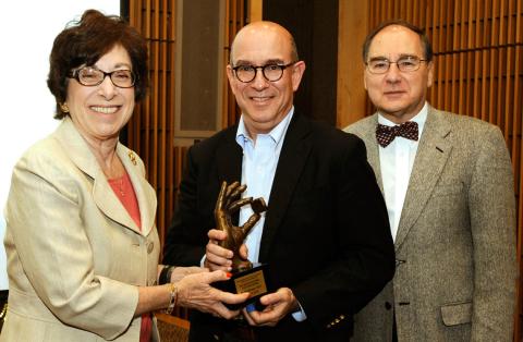 Brown, flanked by Birnbaum and Korach, holds lecture sculpture