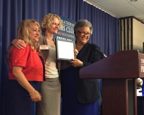 Dr. Volkow holds plaque while posing with two FORCE alliance members.