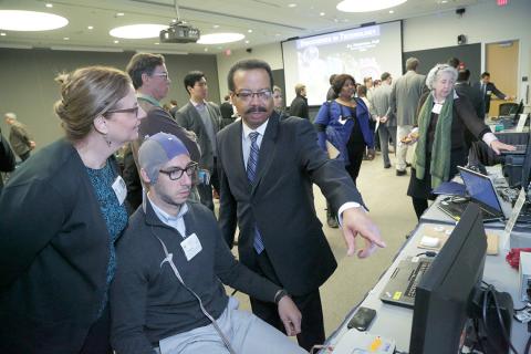 Dr. Pettigrew points to a display.