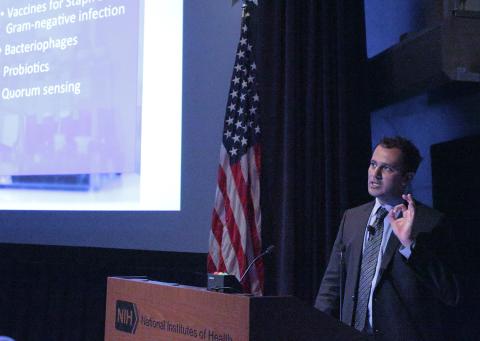 Doctor gestures at podium.