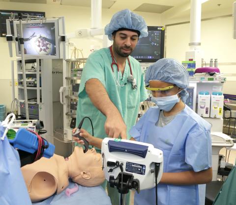 Dr. Yousef points to a screen