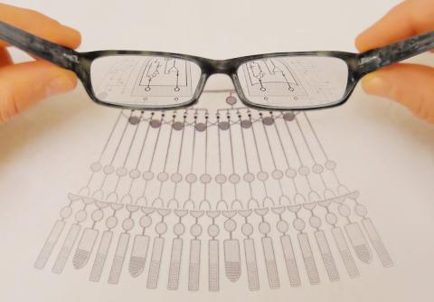 Eyeglasses magnify shapes on a chart.