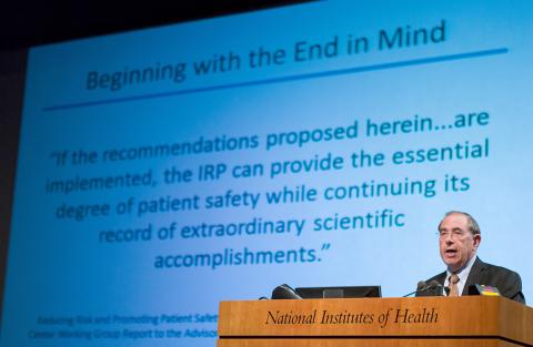 Gallin speaks from podium with slide projected behind him.