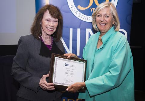 Grady presents plaque to Goodman