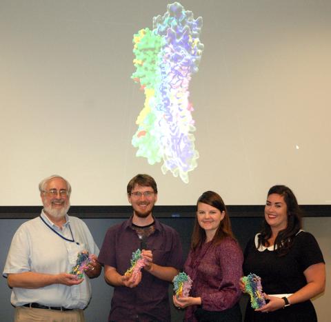 Researchers hold flu models.