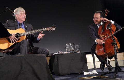 Collins plays his guitar while Ma plays his cello