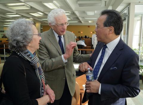 Yo-Yo Ma interacts with two audience members 