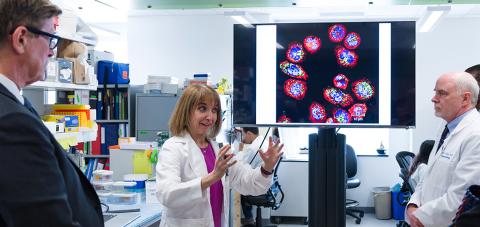 Dr. Kaplan talks with lawmakers visiting the lab