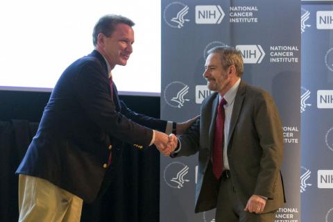 Lowy shakes Sharpless' hand