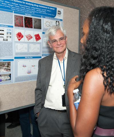 Gottesman smiles as Tanner explains her poster