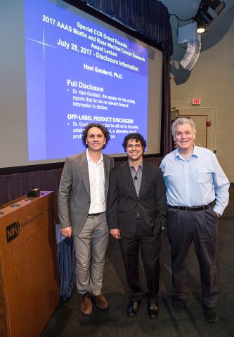 Goodarzi, Mistelli and Berg pose together, standing, smiling on Lipsett Amphitheater stage