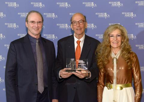 Dr. Roger Glass, holding award, with Tom Hutton and Mara Hutton