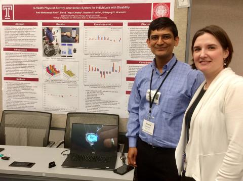 NICHD's Dr. Theresa Cruz visits a poster presented by Temple University’s Shivayogi Hiremath.